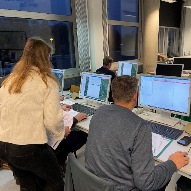 Personen in einem Lehrraum mit Computern
